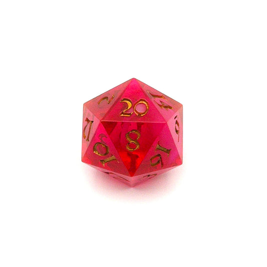 D20 semi-transparent resin die, coloured with red and pink dye, with a soft blur of resin coloured with Piñata Blanco Blanco white in the centre and inked in gold