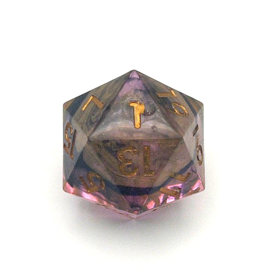 D20 resin dice showing the 1 face, with a small hole filled with UV resin. The resin is semi-transparent pigmented with gold, black and amber dyes. This is inked in gold.