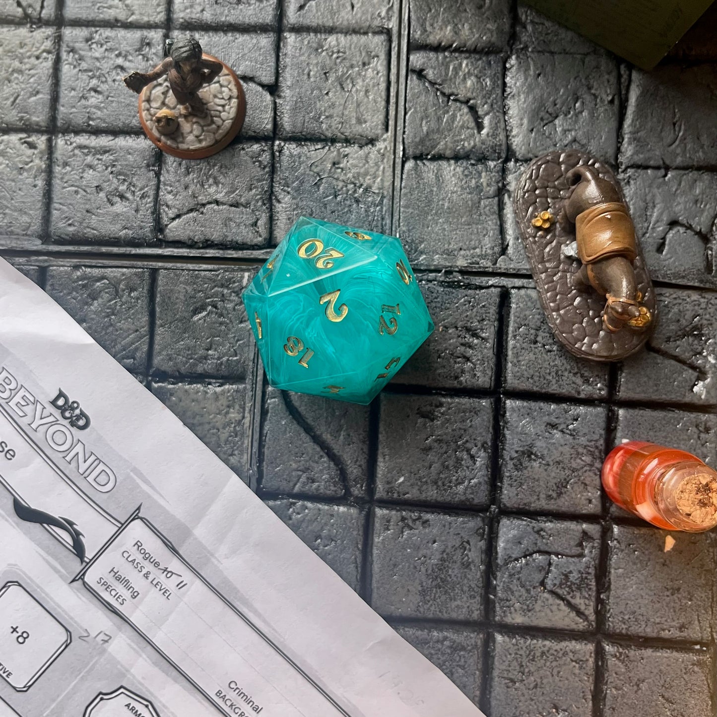 Blue swirl resin chonk blank cast in a clear resin shell, with gold inking. on a gaming background