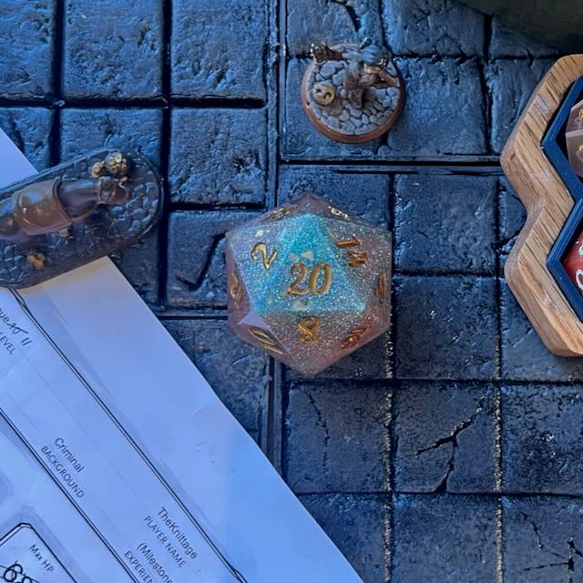 D20 resin Chonk Soft pink and turquoise pearlescent pigment powder and iridescent super fine green glitter on a D&D background