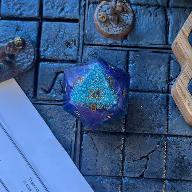 D20 resin Chonk Blue, purple and green pearlescent pigment powder and iridescent super fine green glitter on a D&D background