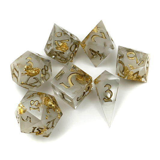 Cloudy white resin dropped into clear resin, with gold flakes. Inking is Gold