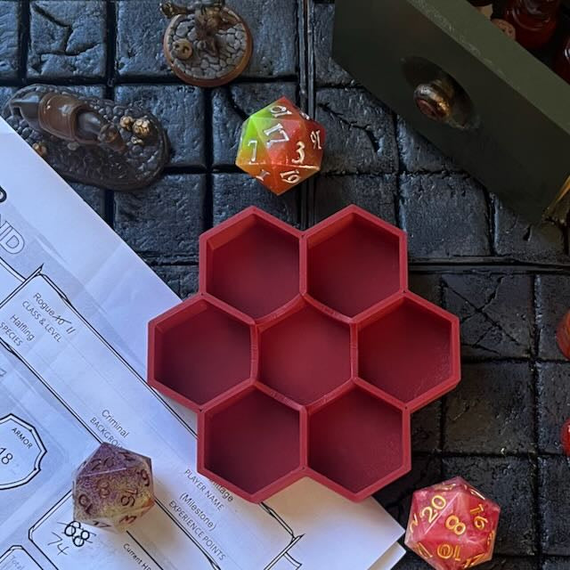 Matte brick red PLA 3D printed hexagonal dice tray on a D&D background