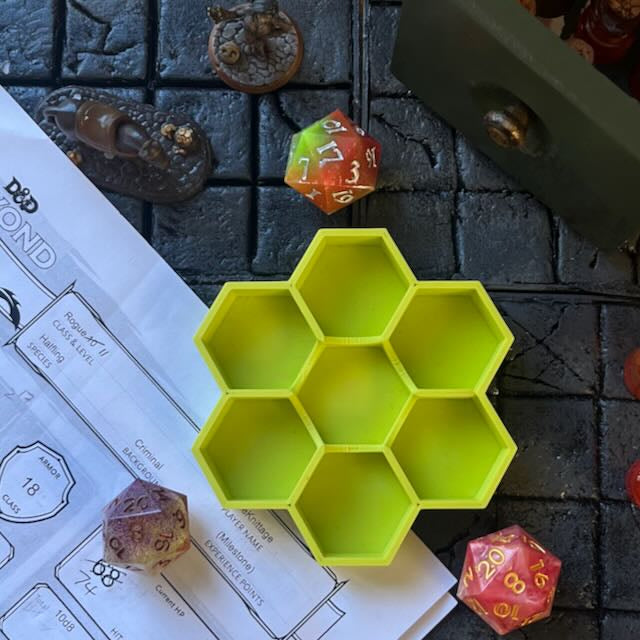 Matte lime green PLA 3D printed hexagonal dice tray on a D&D background