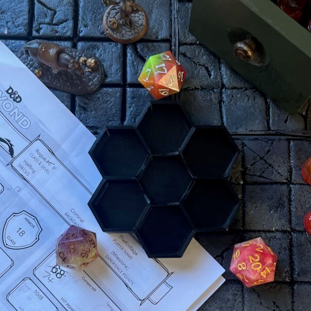 Black PTGE 3D printed hexagonal dice tray on a D&D background