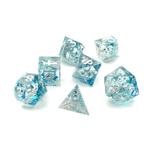 Photo of a set of 7 TTRPG dice made with clear resin and inked in white paint