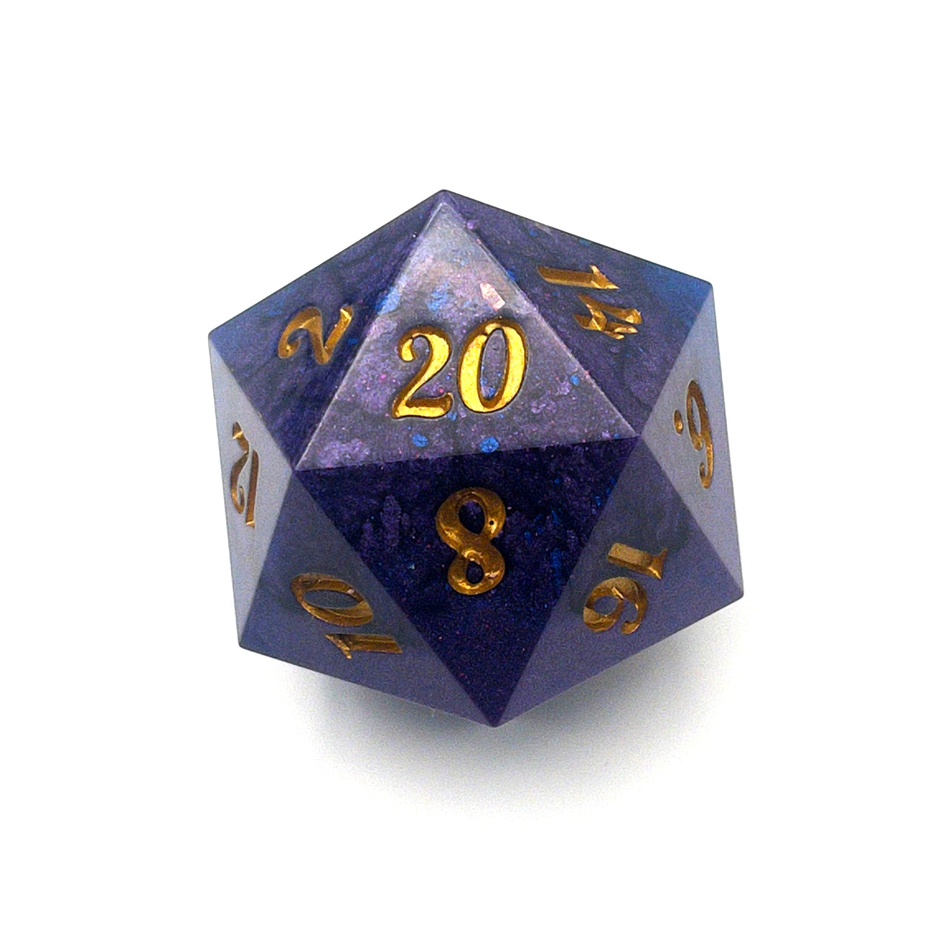D20 chonk dice showing the 20 face. The resin is coloured with pigment powders using black, blue and red. The die is inked in gold.