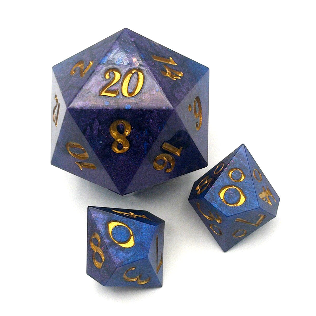 Full set of Mothership dice. The D20 is a chonk, and the D10 and D100 are regular size. The resin is coloured with pigment powders using black, blue and red. The dice are inked in gold.