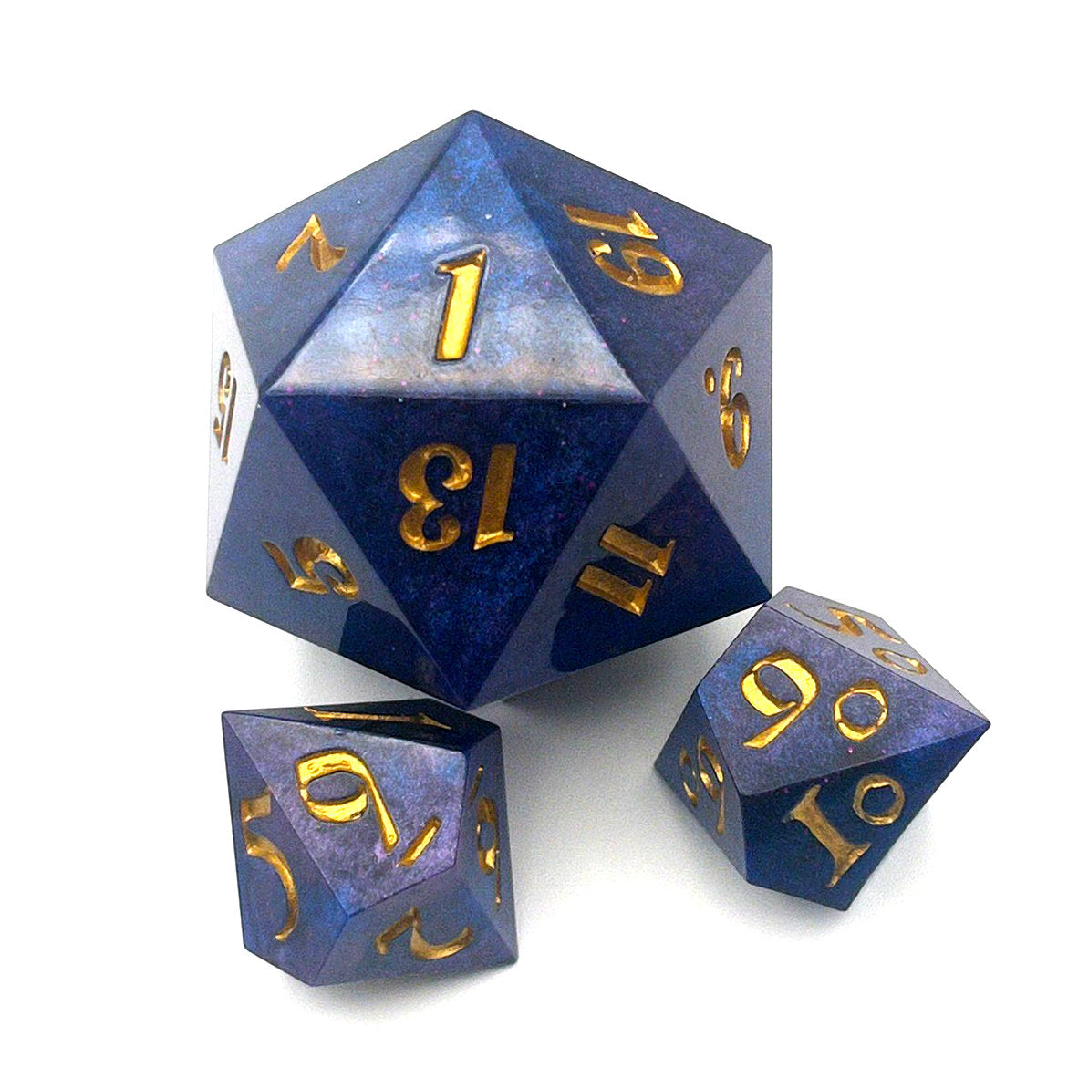 Full set of Mothership dice. The D20 is a chonk, and the D10 and D100 are regular size. The resin is coloured with pigment powders using black, blue and red. The dice are inked in gold.