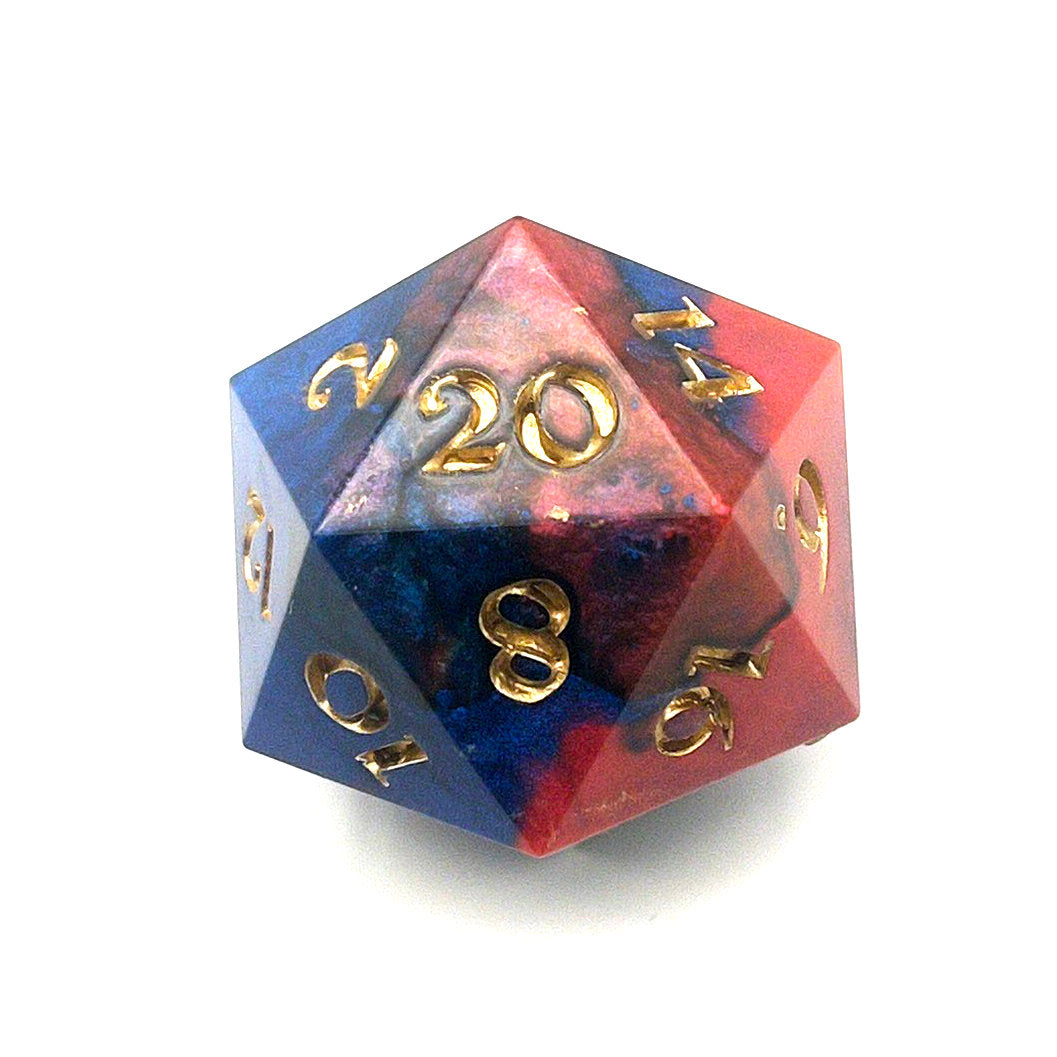 D20 chonk showing the 20 face. The resin is coloured with pigment powders using black, blue and red. The die is inked in chromed gold.