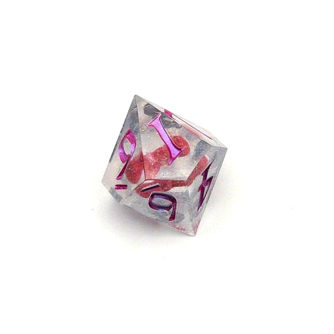 D10 resin dice. Resin is transparent with translucent glitter suspended inside and a red 3D printed hair bow. These are inked in colour-shifting 