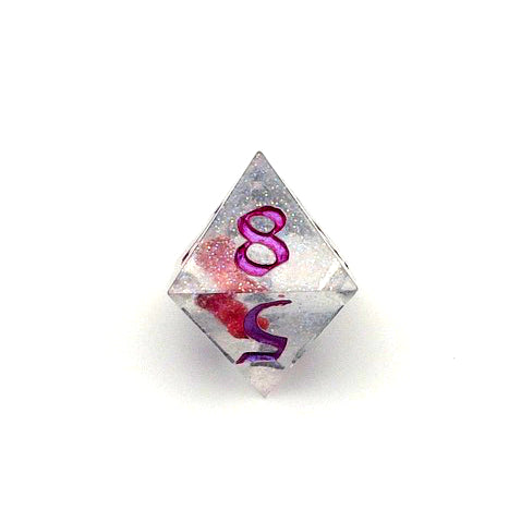 D8 resin dice. Resin is transparent with translucent glitter suspended inside and a red 3D printed hair bow. These are inked in colour-shifting 