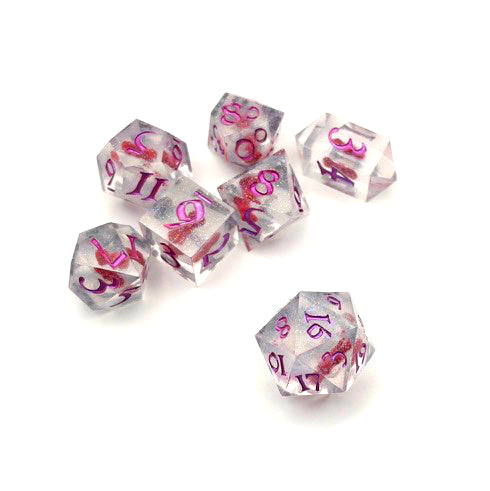 Full set of TTRPG resin dice. Resin is transparent with translucent glitter suspended inside and a red 3D printed hair bow. These are inked in colour-shifting pink pigment