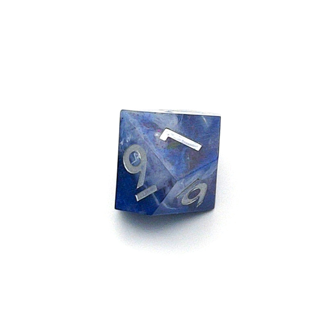 D10 TTRPG resin die, opaque blue in parts, with clear areas with white resin. Inked in silver