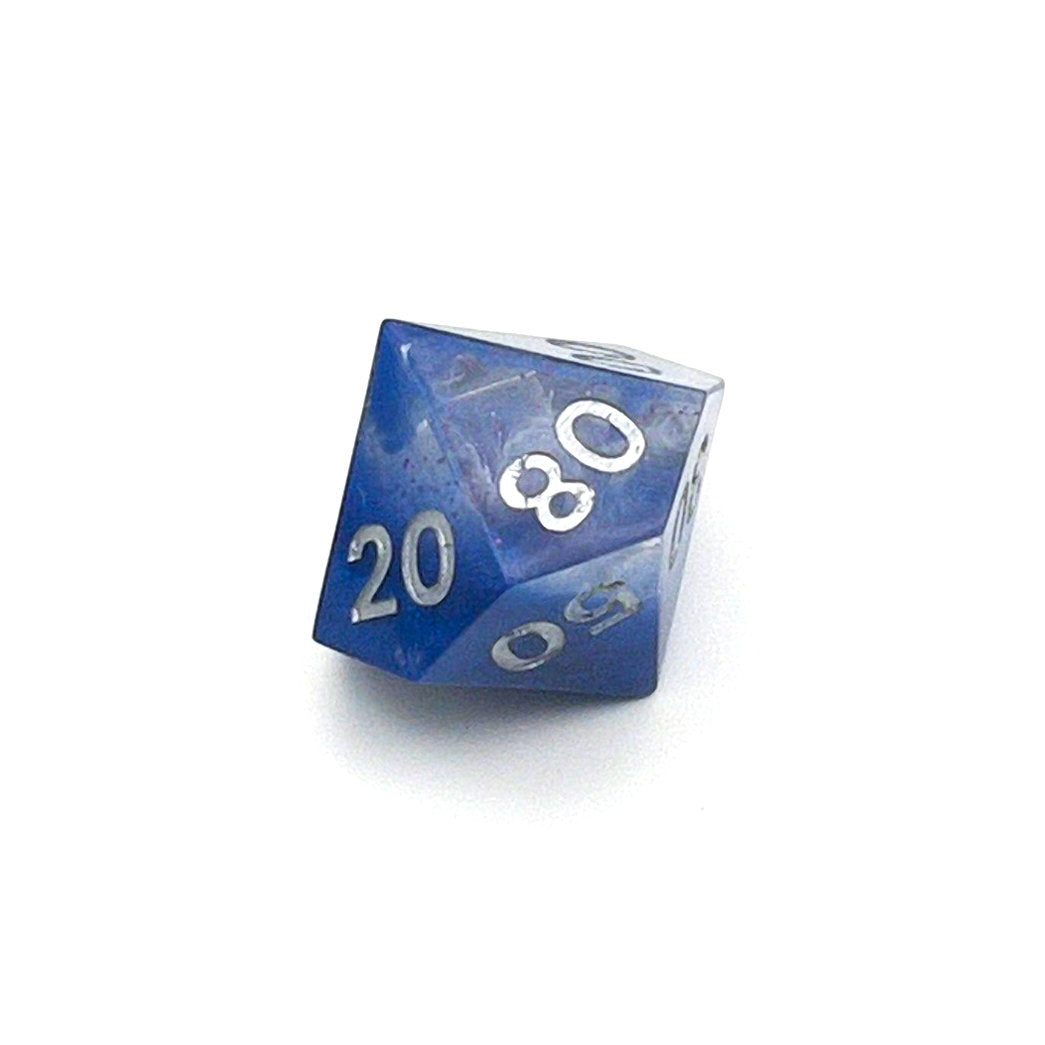 D100 TTRPG resin die, opaque blue in parts, with clear areas with white resin. Inked in silver