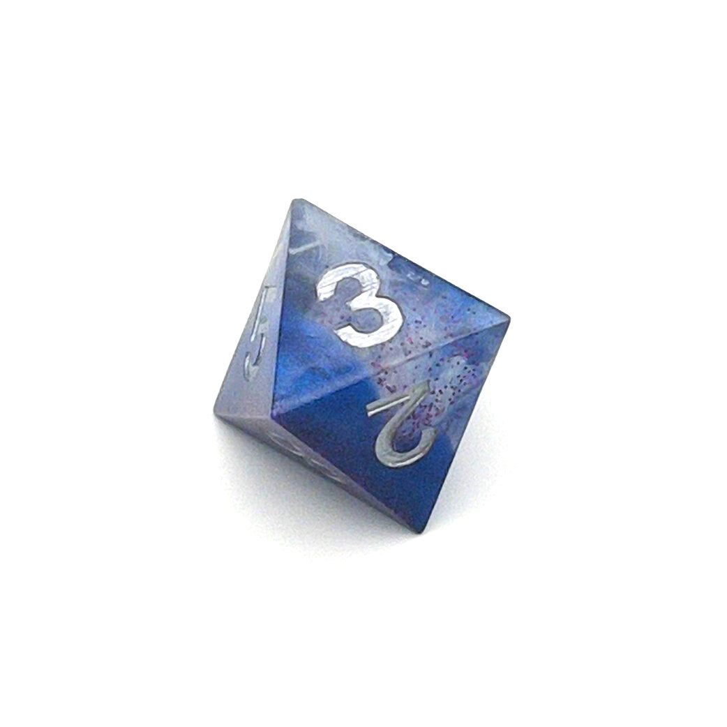 D8 TTRPG resin die, opaque blue in parts, with clear areas with white resin. Inked in silver