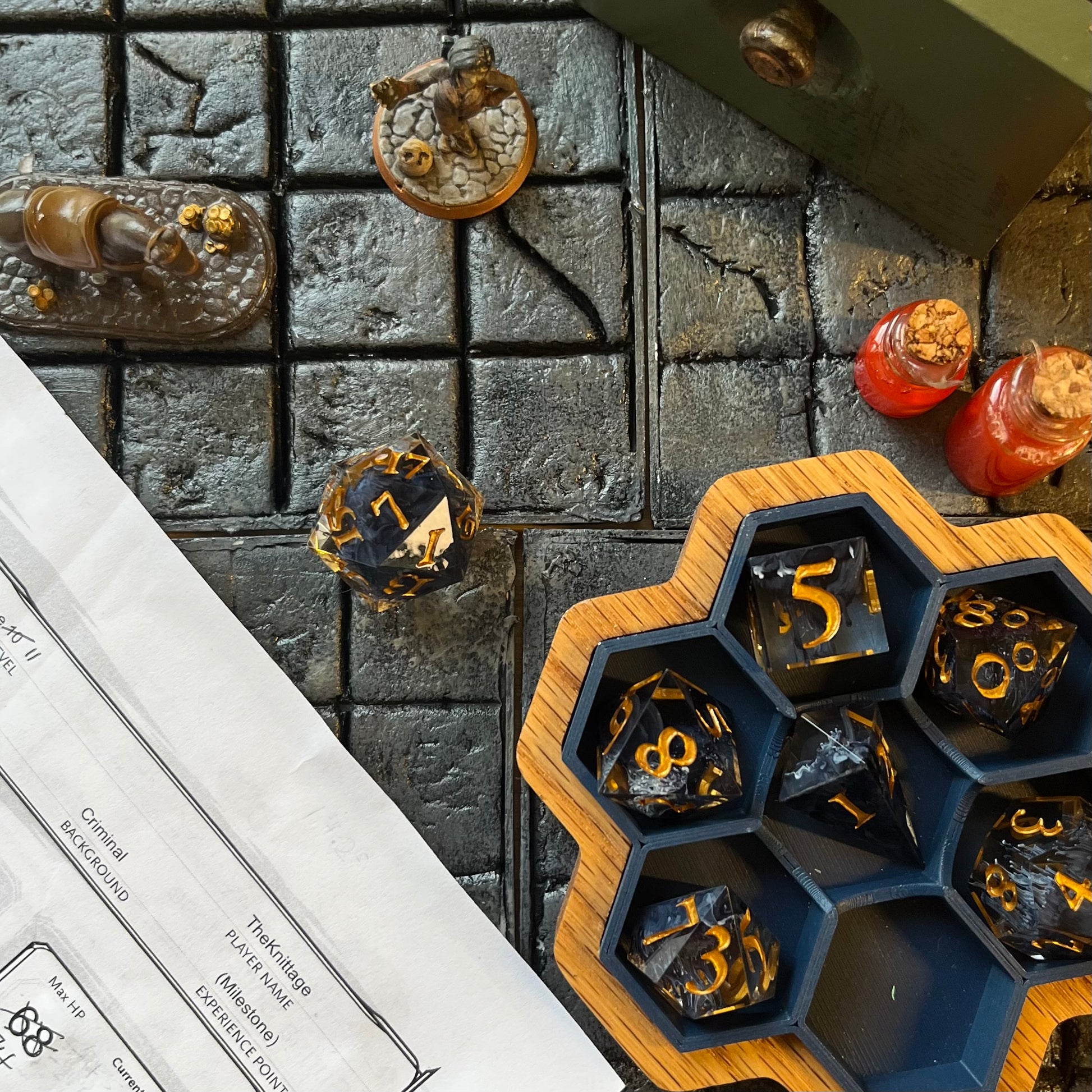 Gold inked ttrpg D&D resin dice set on D&D playing field