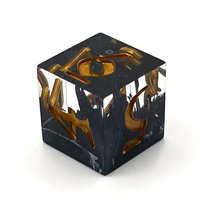 D6 TTRPG resin dice with gold inking. Clear and black resin