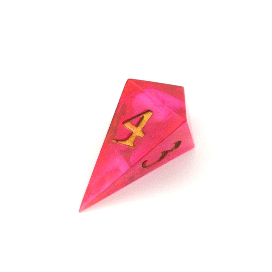 D4 semi-transparent resin die, coloured with red and pink dye, with a soft blur of resin coloured with Piñata Blanco Blanco white in the centre and inked in gold