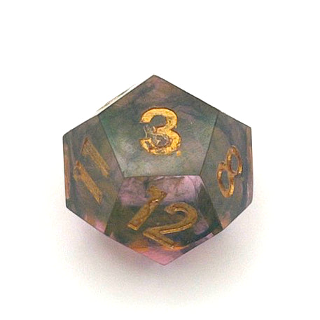 D12 resin dice showing the 3 face, with scratches around the interior of the 3. The resin is semi-transparent pigmented with gold, black and amber dyes. This is inked in gold.