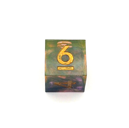 D6 resin dice. The resin is semi-transparent pigmented with gold, black and amber dyes. This is inked in gold.