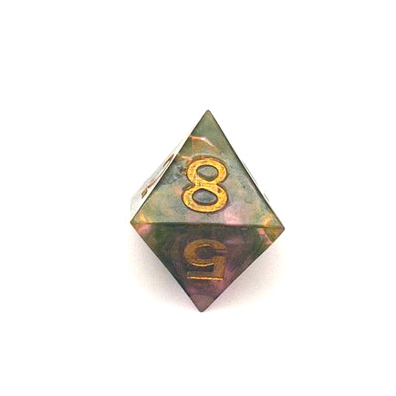 D8 resin dice. The resin is semi-transparent pigmented with gold, black and amber dyes. This is inked in gold.
