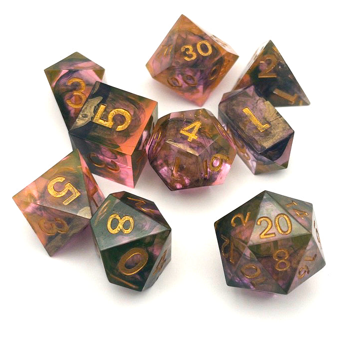 Full set of TTRPG resin dice. Resin is semi-transparent pigmented with gold, black and amber dyes. These are inked in gold
