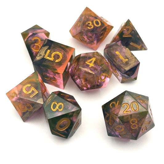 Full set of TTRPG resin dice. Resin is semi-transparent pigmented with gold, black and amber dyes. These are inked in gold