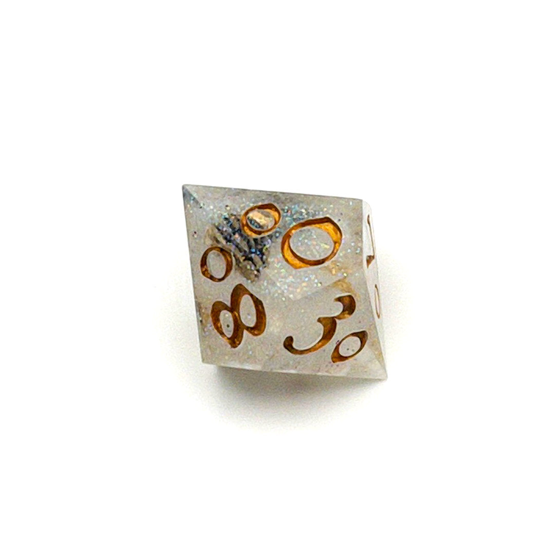 D100 TTRPG die, semi-transparent resin with translucent glitter and angel wing and pearl beads suspended inside. Inked in gold