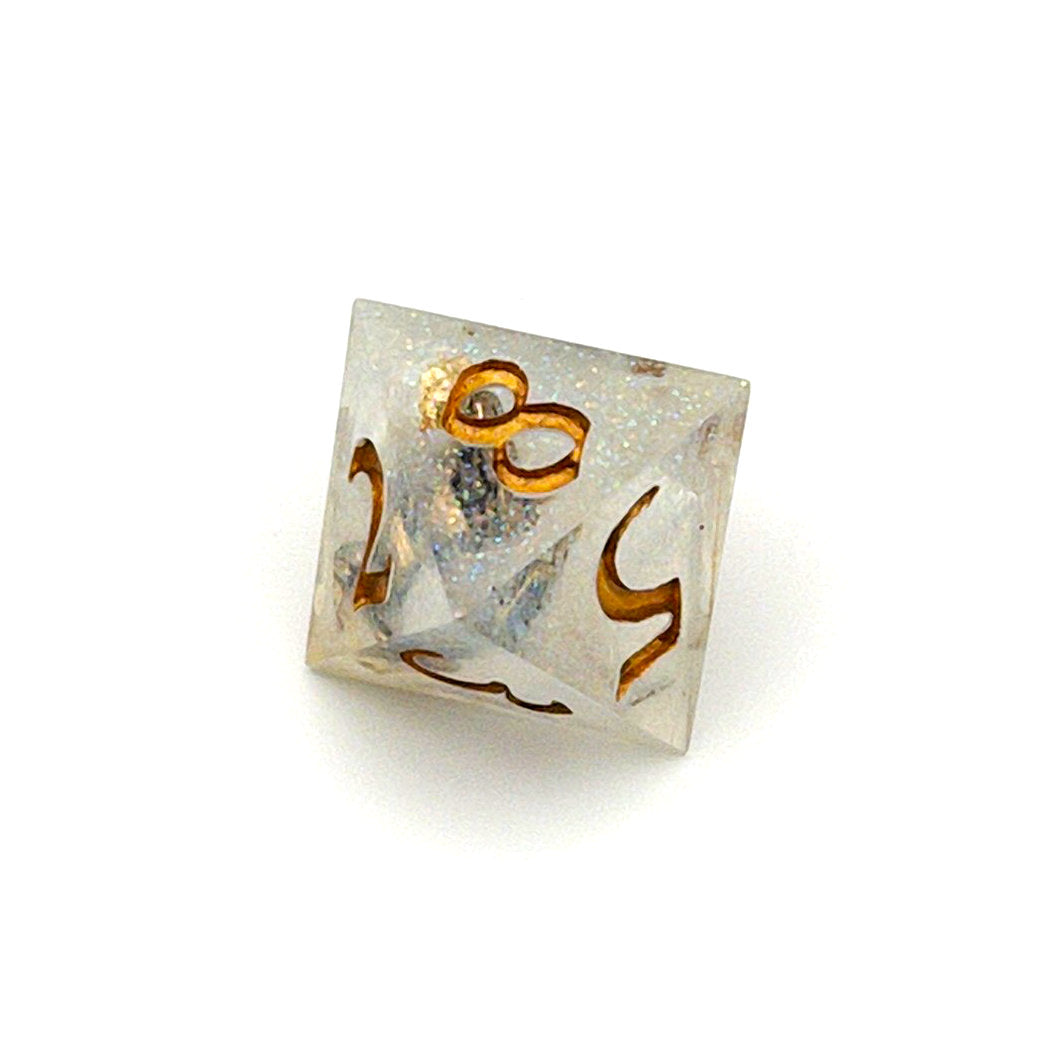 D8 TTRPG die, semi-transparent resin with translucent glitter and angel wing and pearl beads suspended inside. Inked in gold
