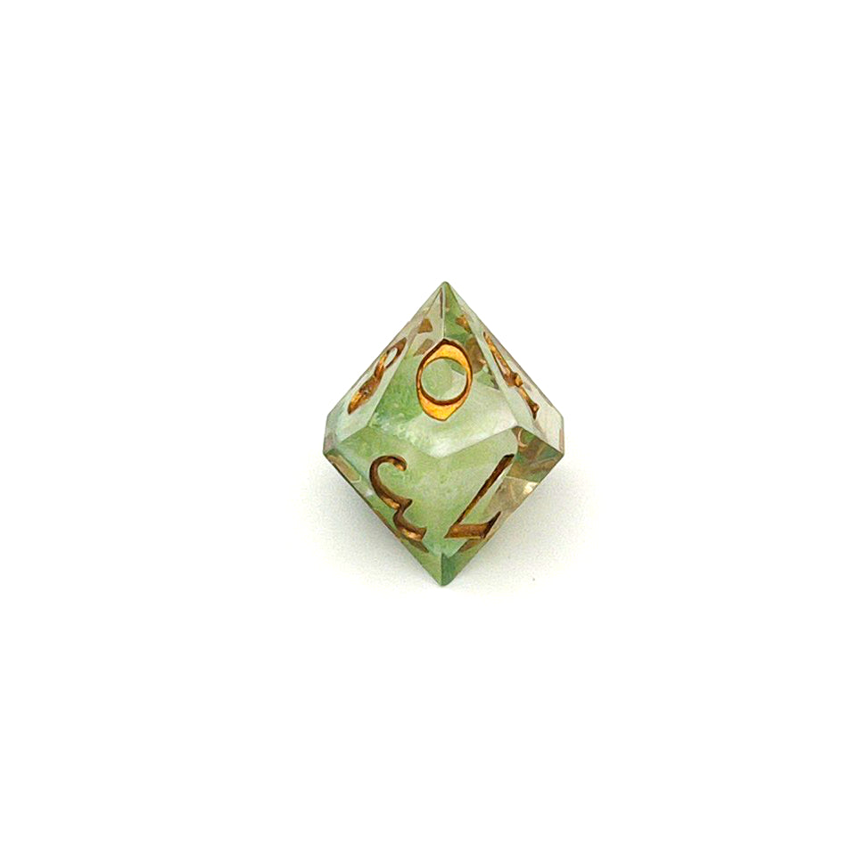 D10 TTRPG resin die, with green and white pigment cast into blanks and then shelled in clear resin and inked in Chromed Gold
