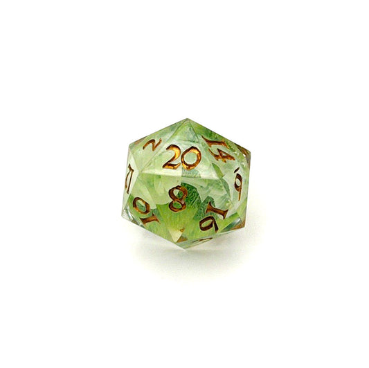 D20 TTRPG resin die, with green and white pigment cast into blanks and then shelled in clear resin and inked in Chromed Gold