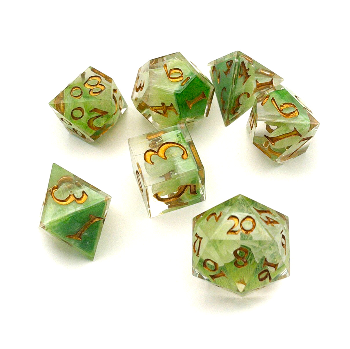Full set of TTRPG resin dice, with green and white pigment cast into blanks and then shelled in clear resin and inked in Chromed Gold