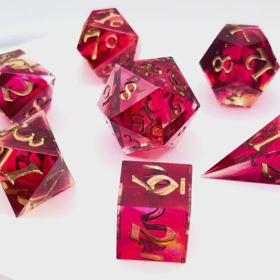 Video sshowing 7 resin TTRPG dice. Scarlet and yellow resin dyes.
Inking is gold