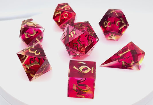 Video sshowing 7 resin TTRPG dice. Scarlet and yellow resin dyes.
Inking is gold