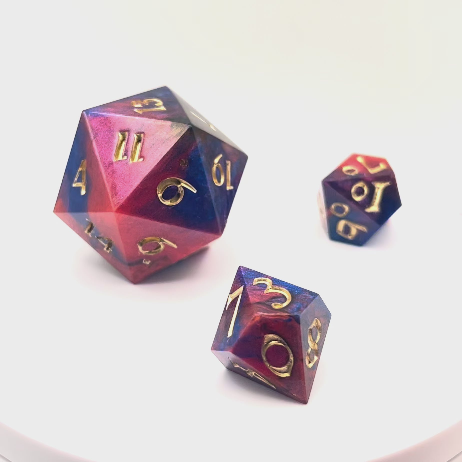 Video showing a full set of Mothership dice. The D20 is a chonk, and the D10 and D100 are regular size. The resin is coloured with pigment powders using black, blue and red. The dice are inked in chromed gold.