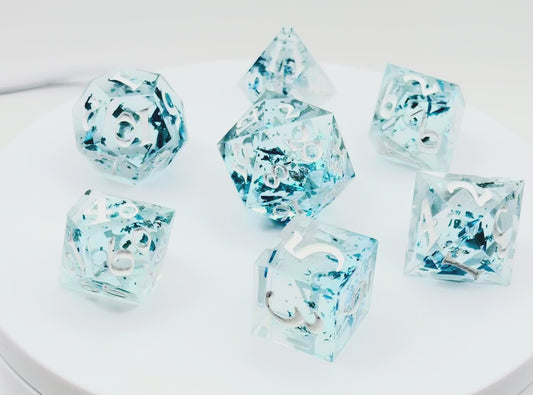 video of a set of 7 TTRPG dice made with clear resin and inked in white paint