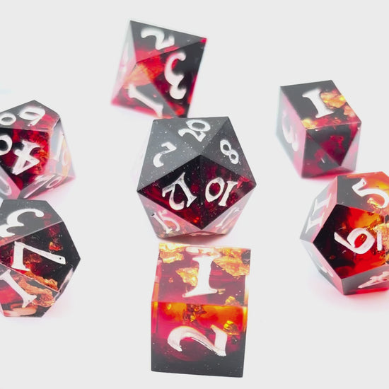 Video showing 7 resin TTRPG dice. Scarlet resin dye, with gold flakes.
Inking is white