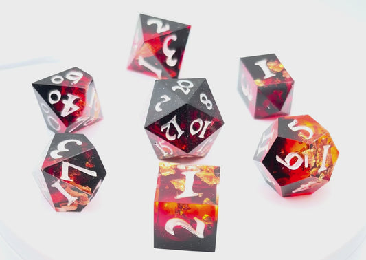 Video showing 7 resin TTRPG dice. Scarlet resin dye, with gold flakes.
Inking is white