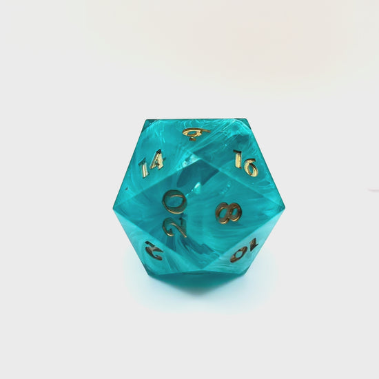 Video showing blue swirl resin chonk blank cast in a clear resin shell, with gold inking. The tunnel through the swirling colour is shown