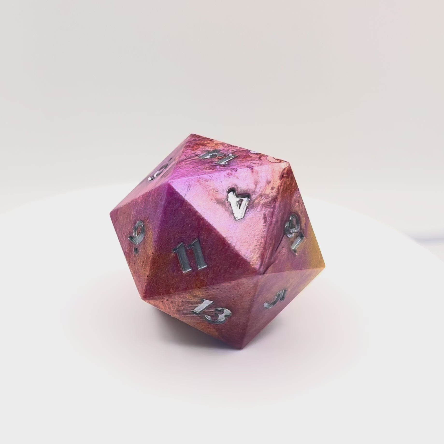 Video of opaque resin chonk coloured with gold, bronze and purple pigment powder, with tiny iridescent stars and crescent moons. Inking is in silver